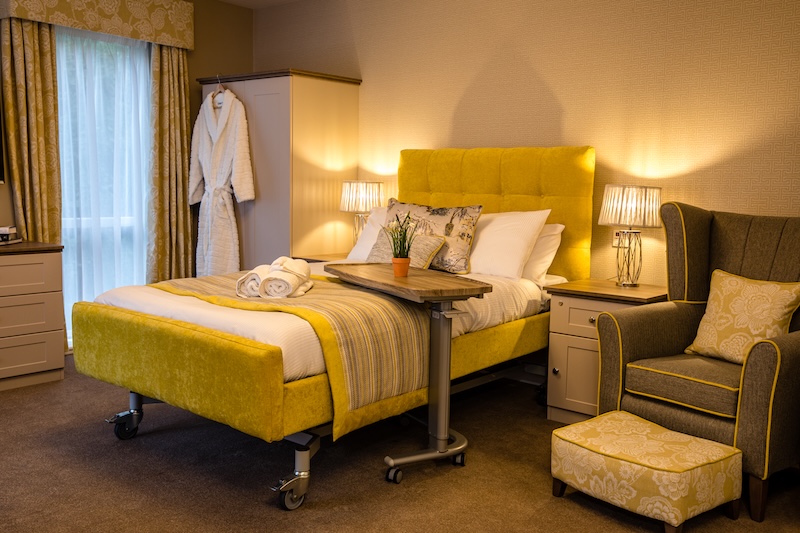 Priorslee House bedroom with yellow bedding and armchair
