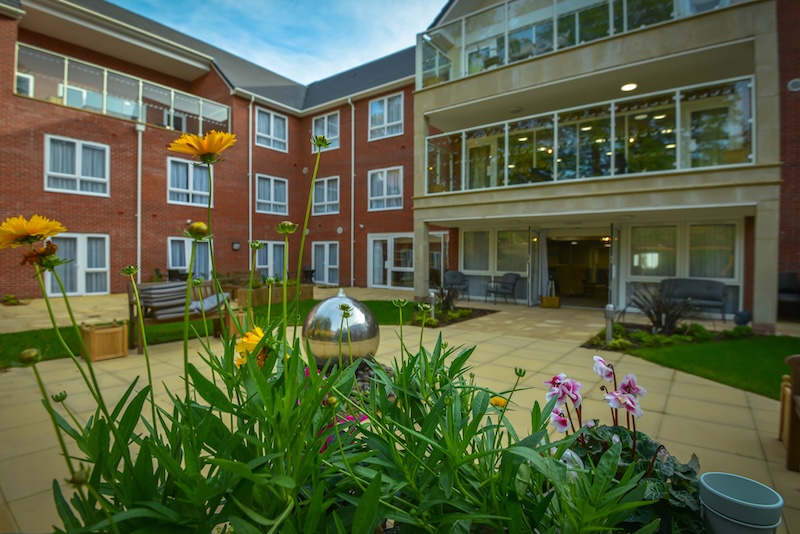 Priorslee House exterior with patio and flowers